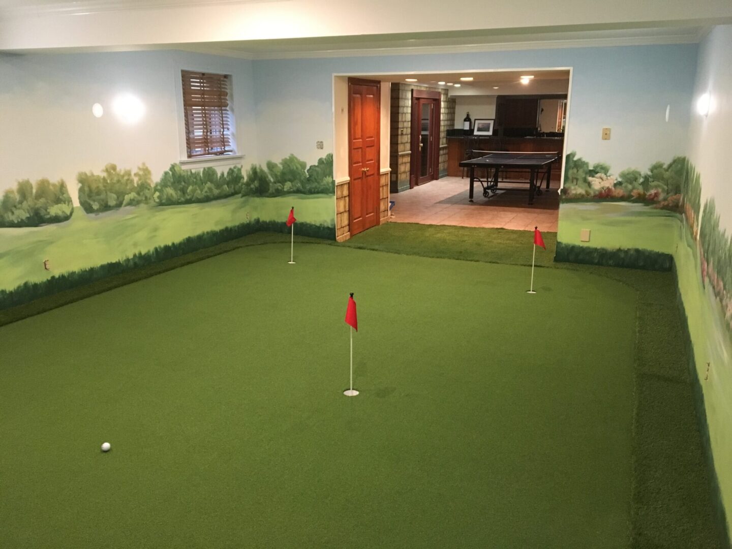 A room with a golf course and putting green.