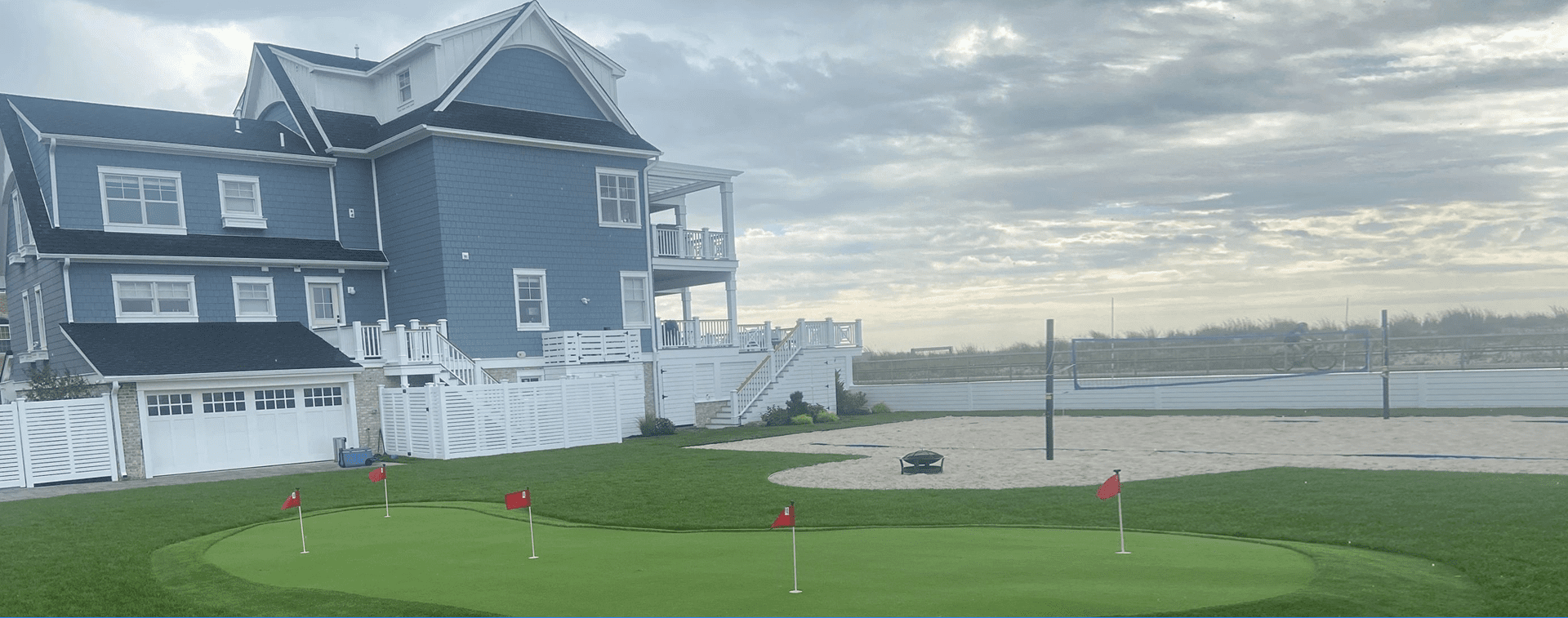 A house with a golf course and a green